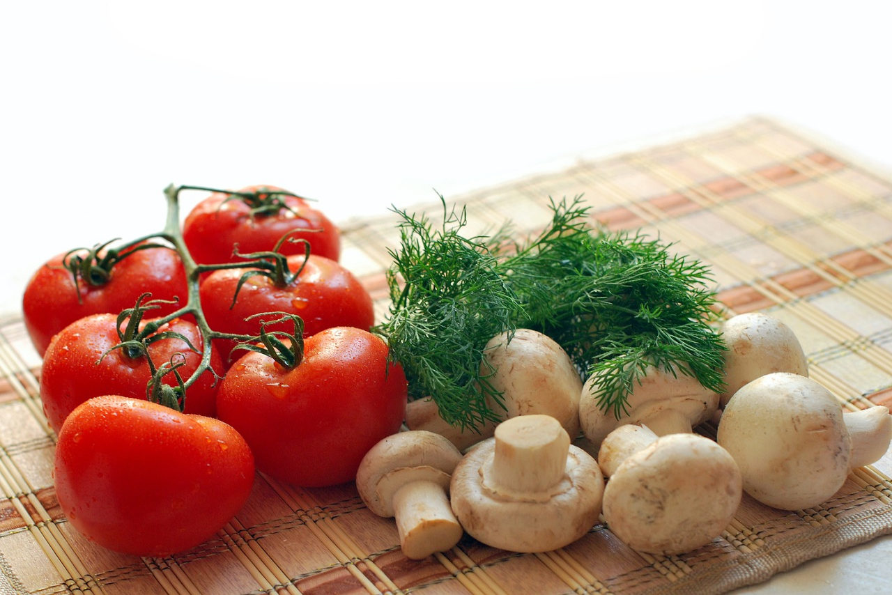 Tomatoes, parsley and mushrooms on a wooden table